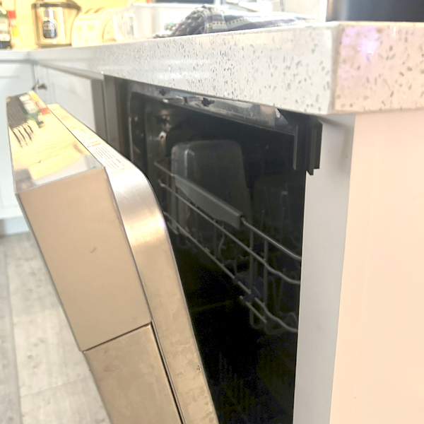 Dishwasher door open into kitchen workspace without a door holder
